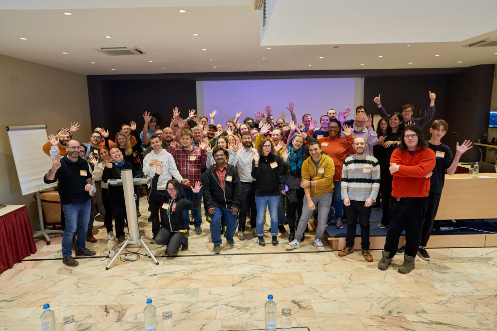 CHAOSS attendees acting silly in a group