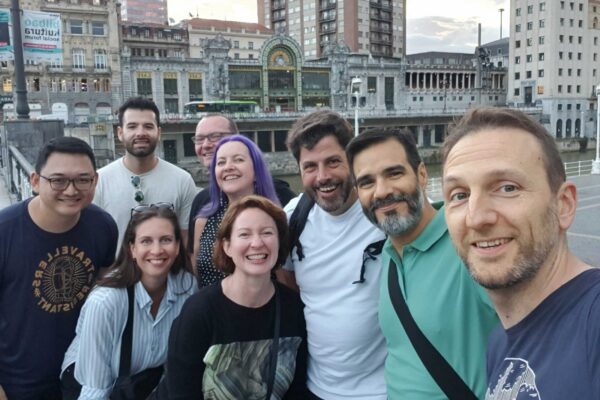 CHAOSS Crew in Bilbao A group of CHAOSS community members taking a selfie on the bridge leading to the Bilbao old town area