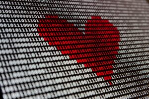A bunch of white ones and zeros on a black background with a heart shape of ones and zeros in the middle